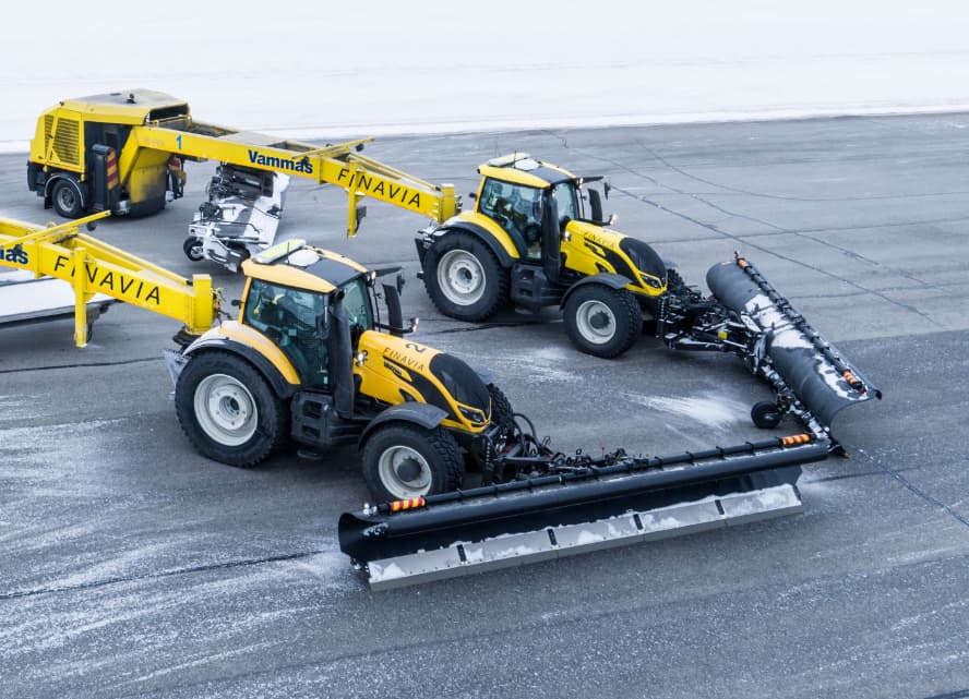 Two snow-plowing Valtra tractors